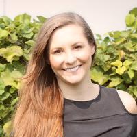 Woman with long brown hair smiling at camera