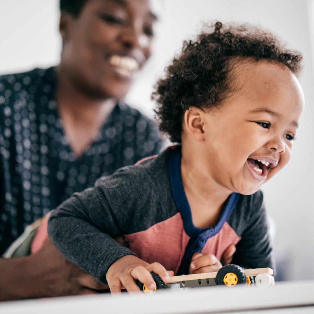 baby laughing with mom