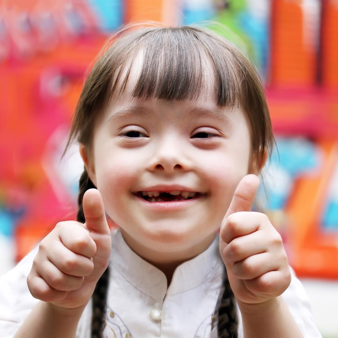 Child with Down's syndrome with thumbs up