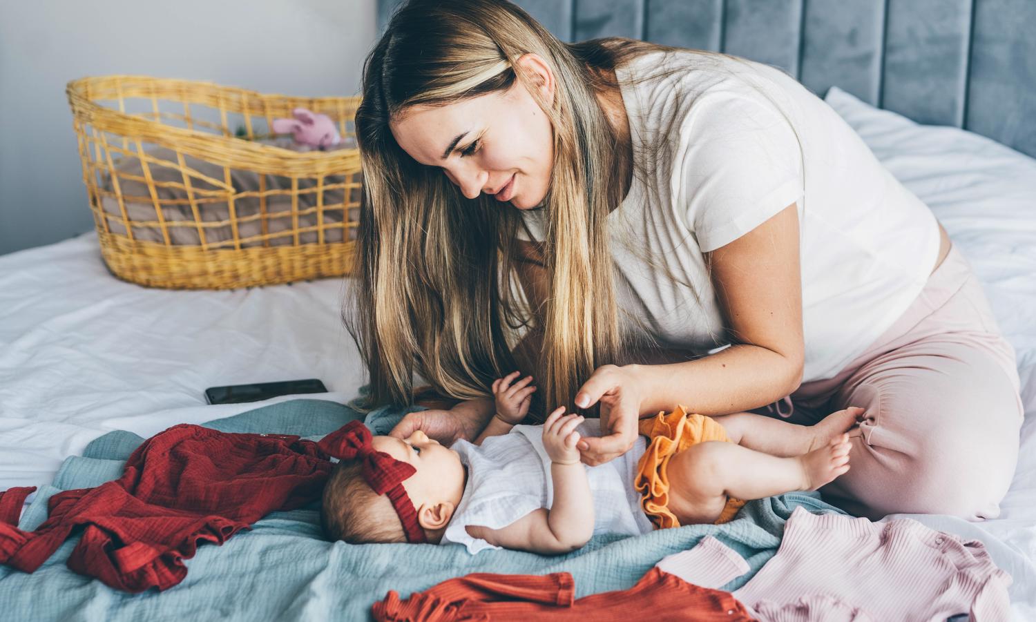 mom and baby on bed