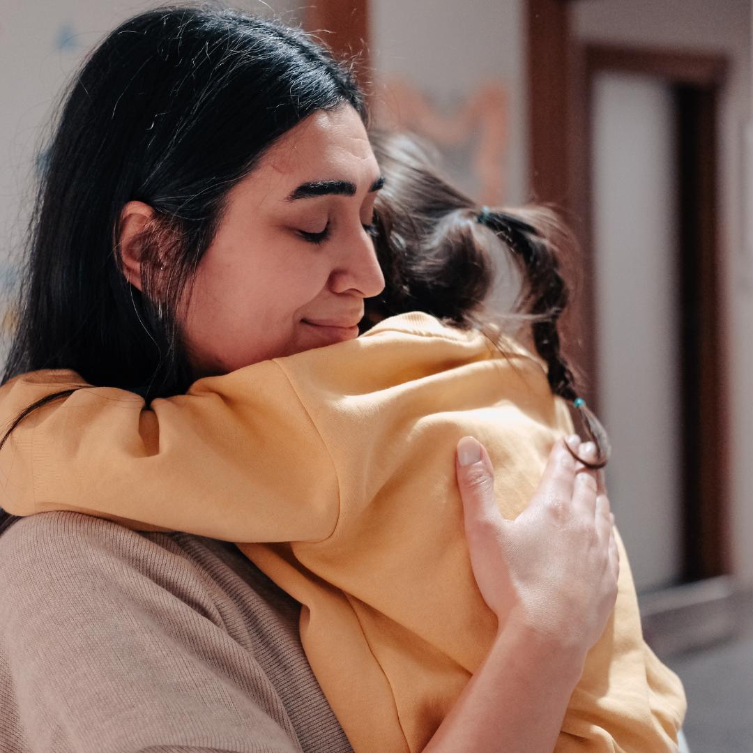 Distraught mom hugging daughter