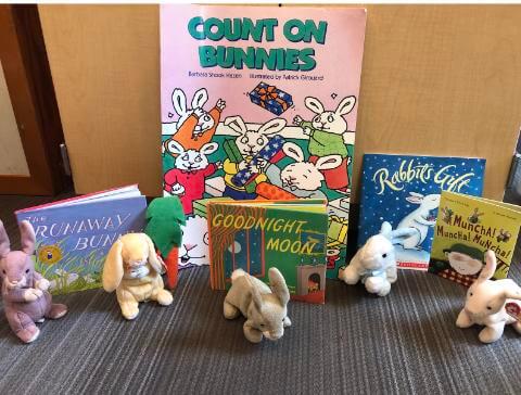 Rabbit stuffed animals and books
