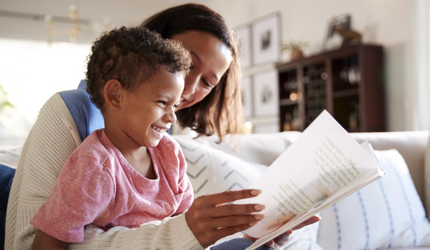 Mother and child reading and laughing