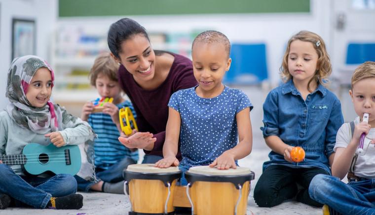 teacher and children playing music 