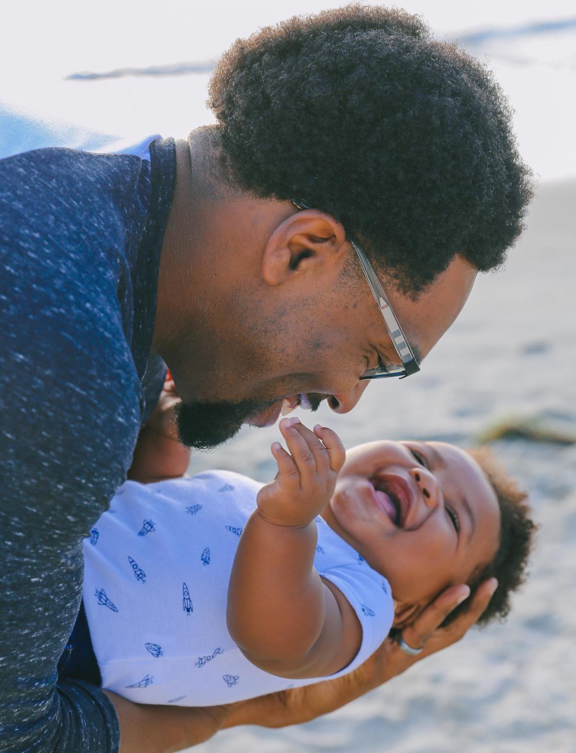 parent and baby smiling 