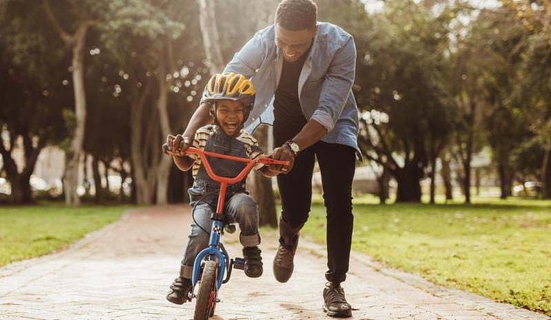 man and child riding bike