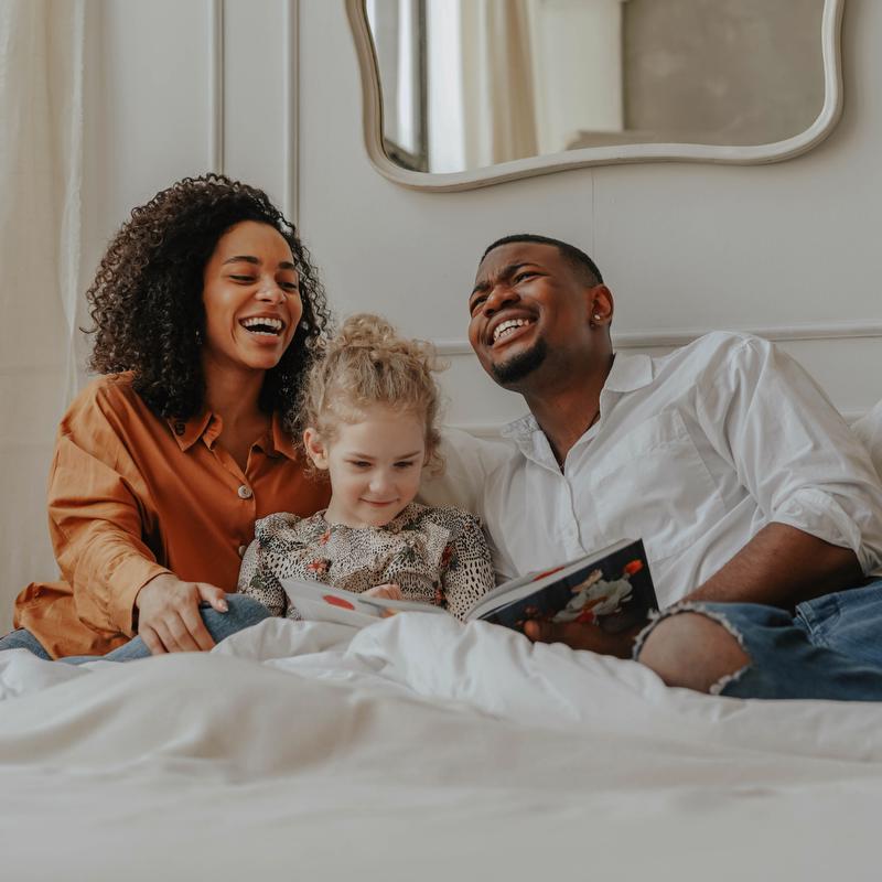 Adoptive family reading in bed