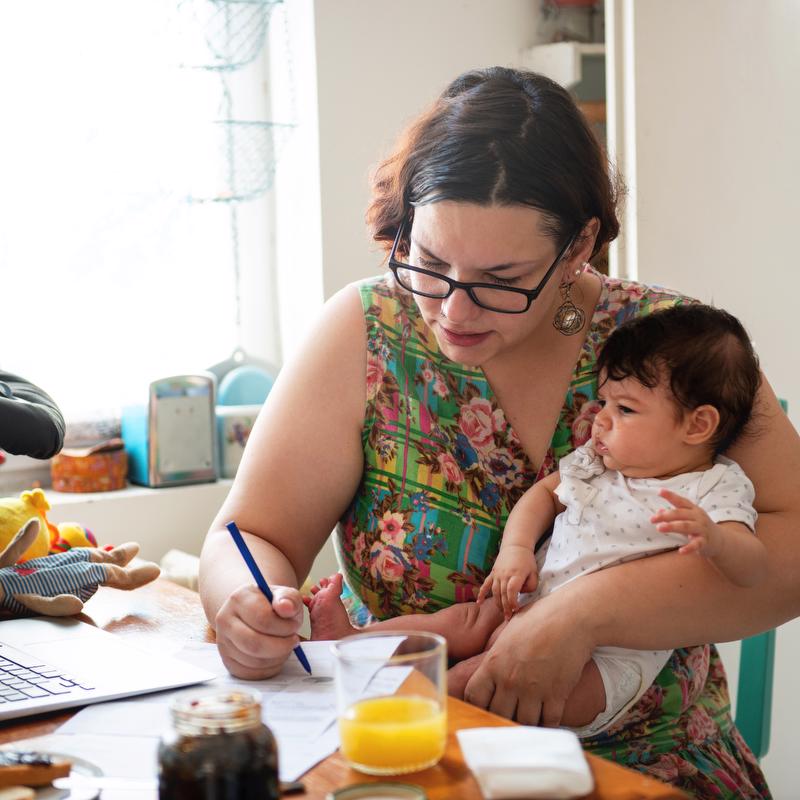 mom working with baby on lap