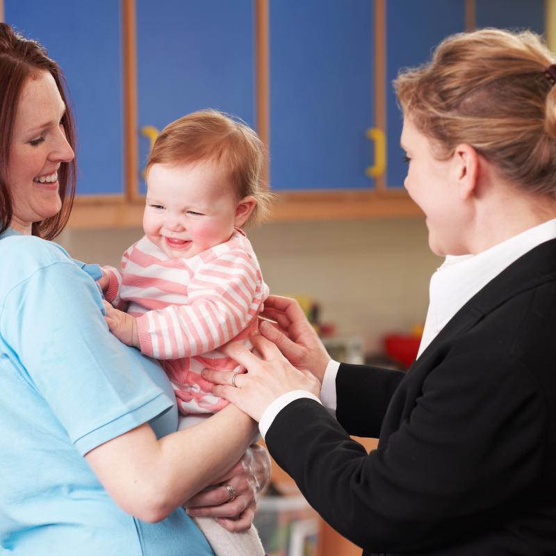 Mom dropping off baby at child care