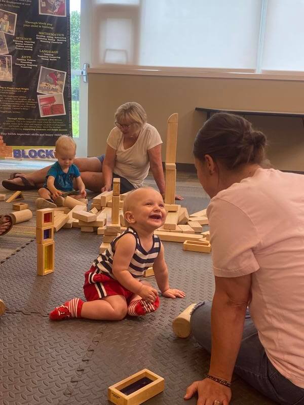 Adults and toddler smiling