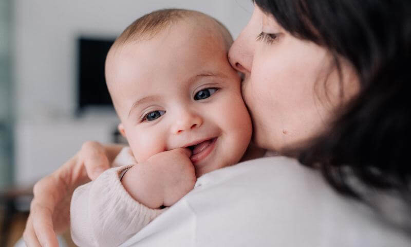 mom holding baby