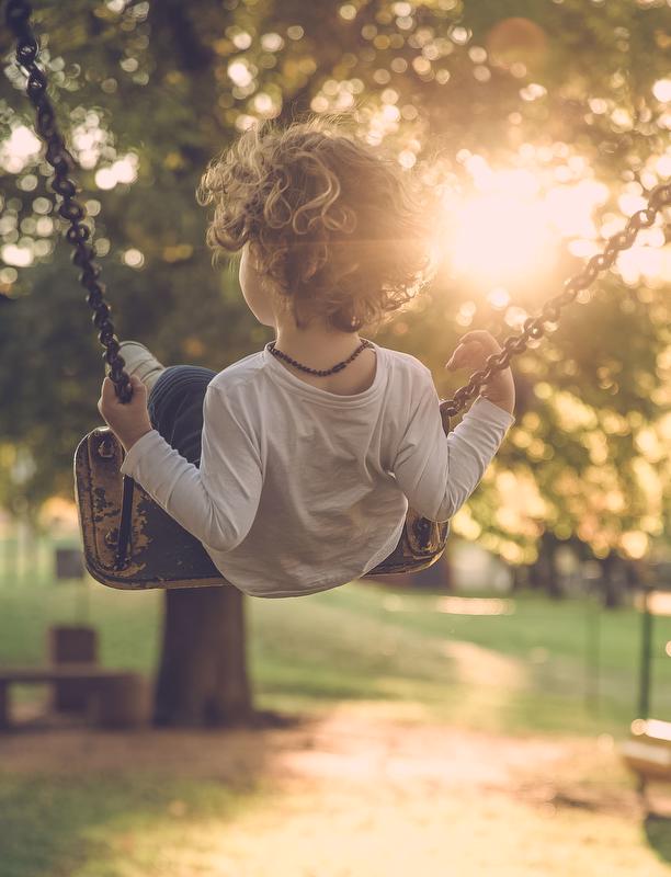 child on a swing in the park 